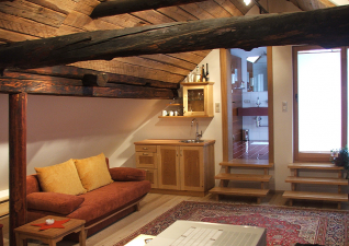 Nowadays the former barn in the upper floor is a spacious living room (Gallery view)